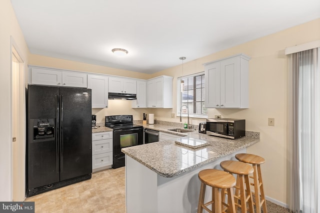 kitchen with white cabinets, sink, kitchen peninsula, and black appliances