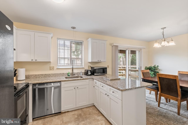 kitchen featuring white cabinetry, sink, hanging light fixtures, stainless steel appliances, and a notable chandelier