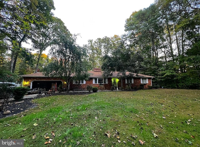 single story home featuring a front lawn and a garage