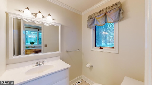 bathroom with vanity, toilet, and ornamental molding