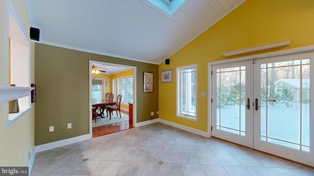 doorway to outside with ceiling fan, lofted ceiling with skylight, and french doors