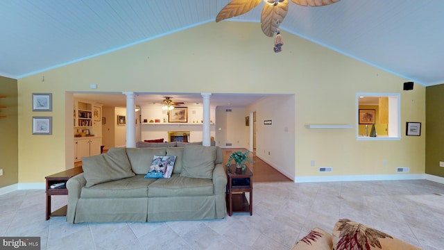 living room with ceiling fan, built in features, high vaulted ceiling, and decorative columns