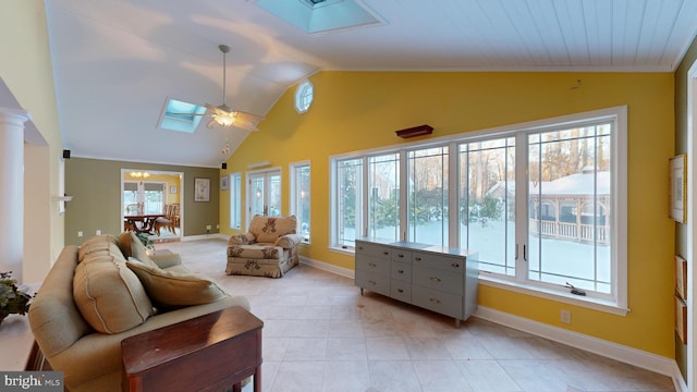 living room with ceiling fan, crown molding, and lofted ceiling with skylight