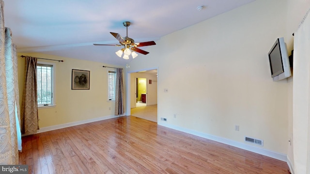 empty room featuring light hardwood / wood-style flooring, ceiling fan, and lofted ceiling