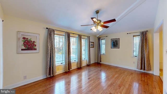 unfurnished room with ceiling fan, light hardwood / wood-style flooring, and vaulted ceiling