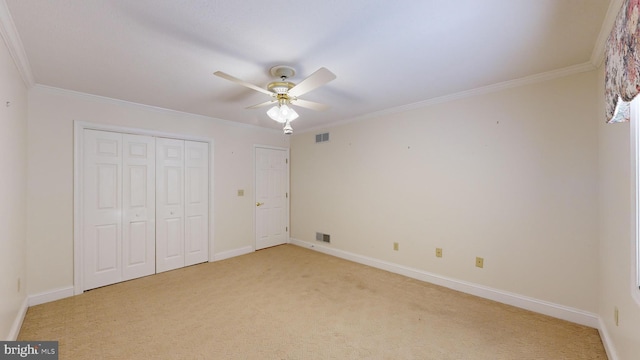 unfurnished bedroom featuring ceiling fan, light carpet, and ornamental molding