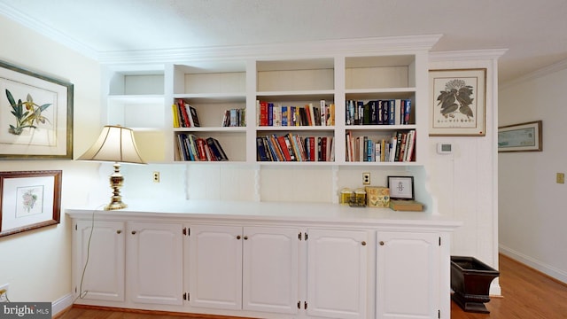 details featuring hardwood / wood-style floors and crown molding