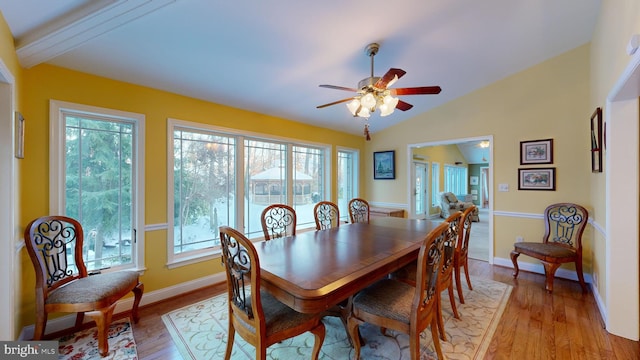 dining area featuring lofted ceiling with beams, light hardwood / wood-style floors, and ceiling fan