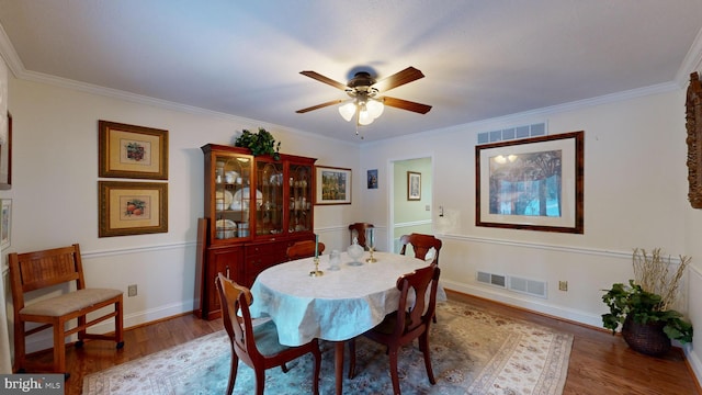 dining room with ceiling fan, hardwood / wood-style floors, and ornamental molding