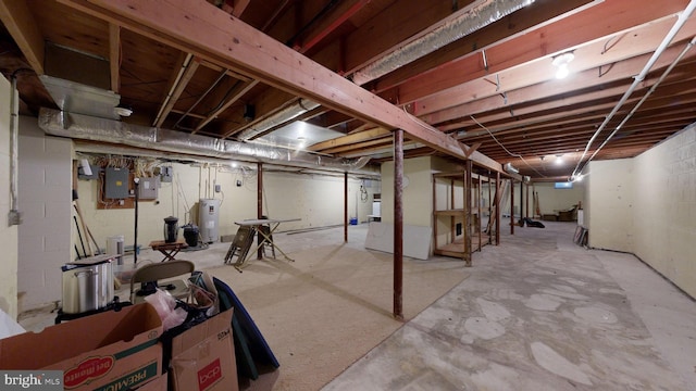 basement featuring electric water heater and electric panel