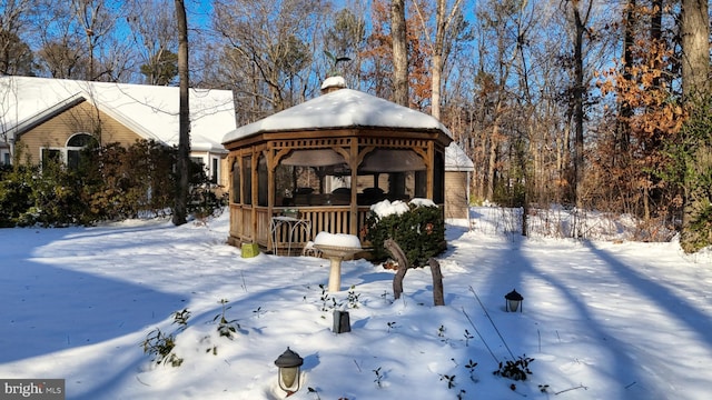 snowy yard with a gazebo