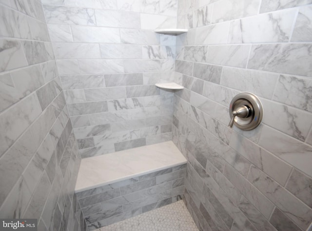 bathroom featuring tiled shower