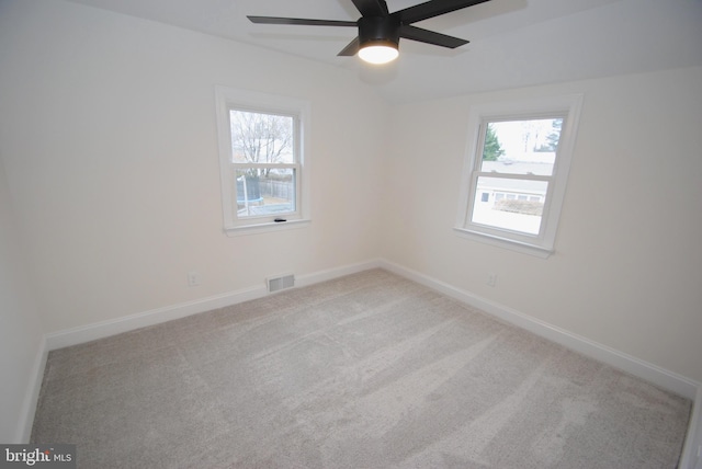 spare room with light carpet and ceiling fan