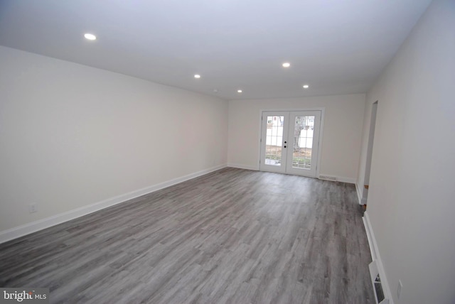 empty room featuring french doors and light hardwood / wood-style floors