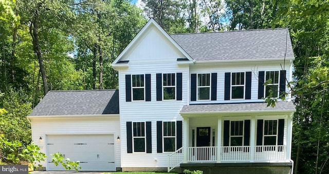 view of front of house with covered porch and a garage