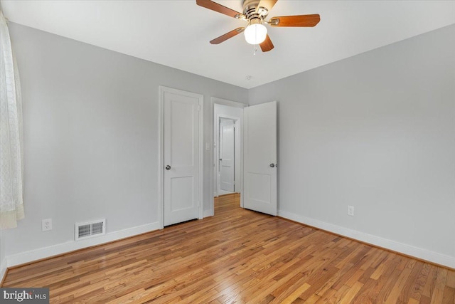 unfurnished room with ceiling fan and light wood-type flooring