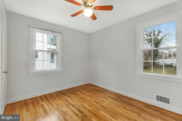 spare room with ceiling fan and light wood-type flooring