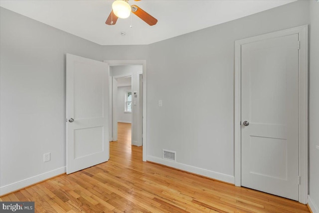 unfurnished bedroom with ceiling fan and light hardwood / wood-style floors