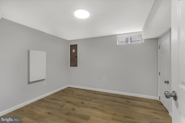 spare room featuring hardwood / wood-style floors and electric panel