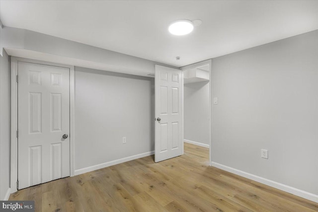 basement with light hardwood / wood-style flooring