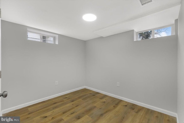 basement with hardwood / wood-style floors and a wealth of natural light