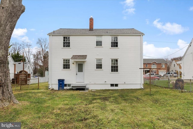 rear view of house featuring a yard