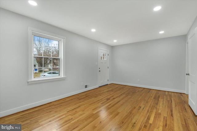 spare room featuring light hardwood / wood-style floors