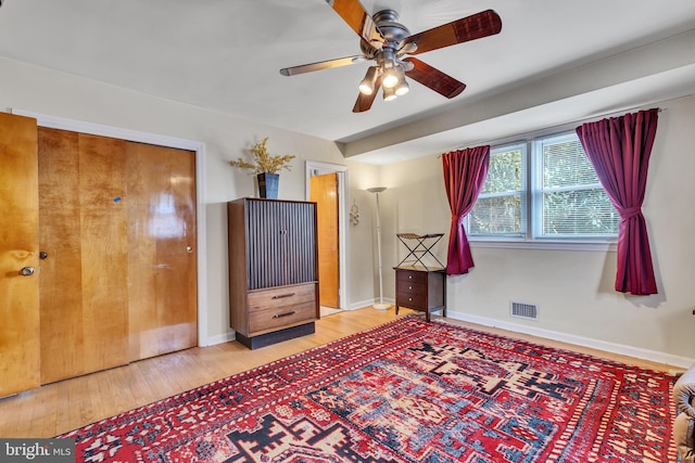 interior space with light wood-type flooring, a closet, and ceiling fan