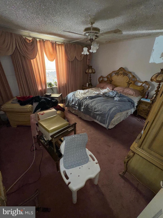 carpeted bedroom with ceiling fan and a textured ceiling