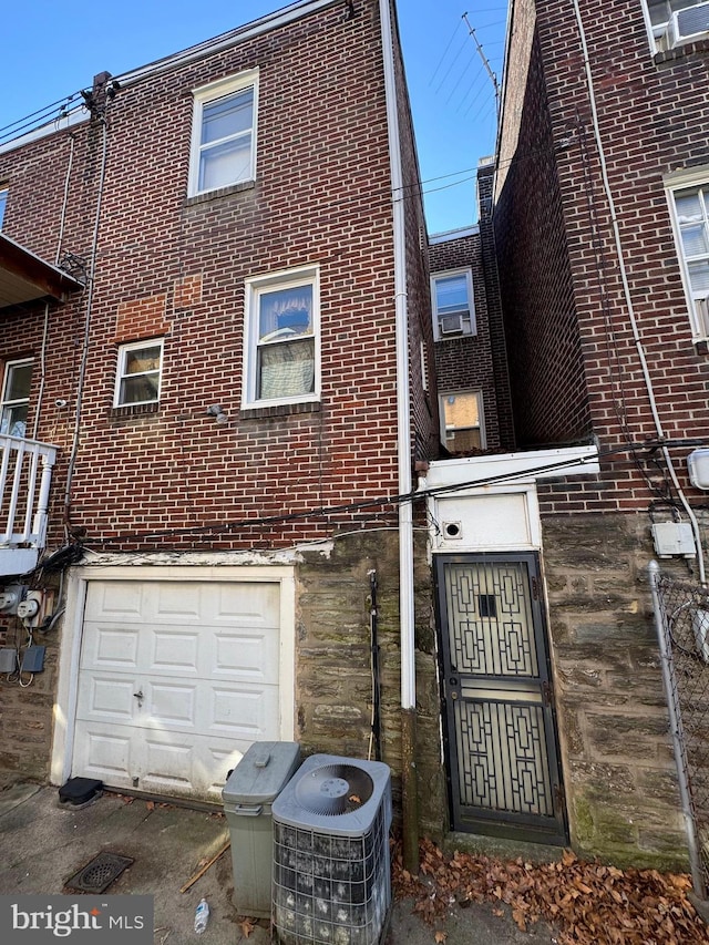 view of side of home with central AC