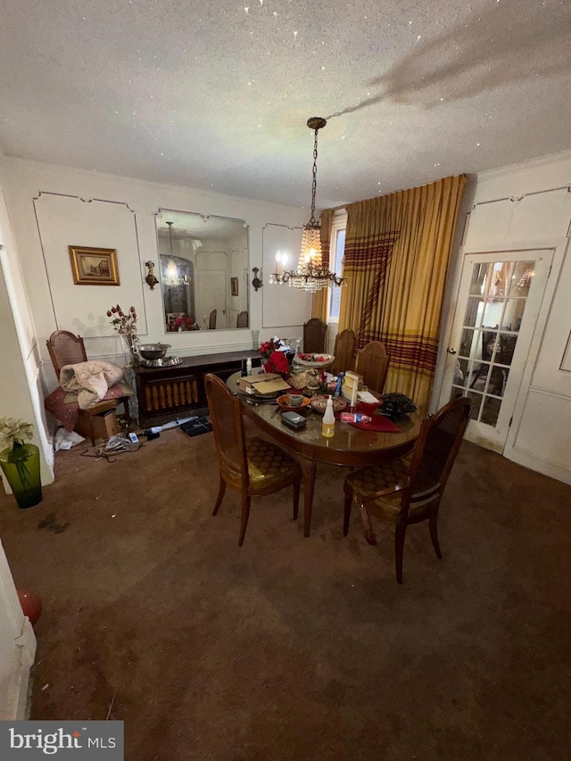 dining space with a chandelier, a textured ceiling, and carpet flooring