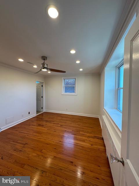 spare room featuring ceiling fan, dark hardwood / wood-style floors, and ornamental molding