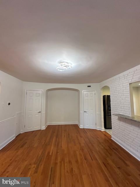 unfurnished living room featuring hardwood / wood-style flooring