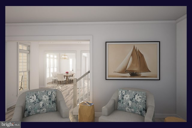 sitting room featuring a chandelier and ornamental molding