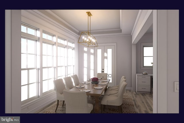 dining space featuring hardwood / wood-style floors, a healthy amount of sunlight, and a chandelier