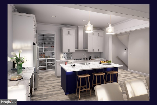 kitchen with white cabinets, light wood-type flooring, light stone countertops, and a kitchen island with sink