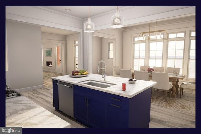 kitchen with sink, blue cabinets, a kitchen island with sink, and hanging light fixtures