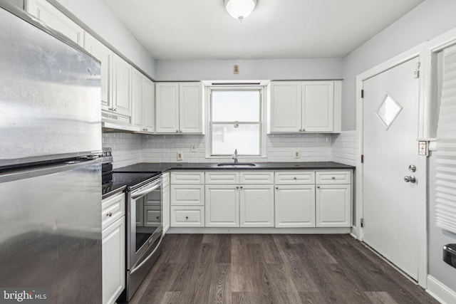 kitchen with dark hardwood / wood-style flooring, white cabinetry, sink, and stainless steel appliances