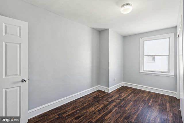 spare room with dark hardwood / wood-style flooring