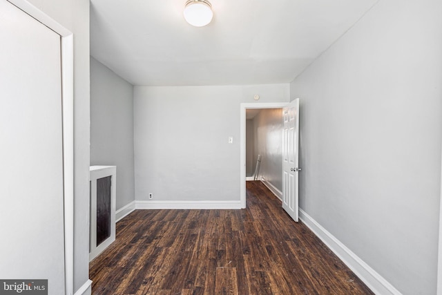 unfurnished living room featuring dark hardwood / wood-style flooring