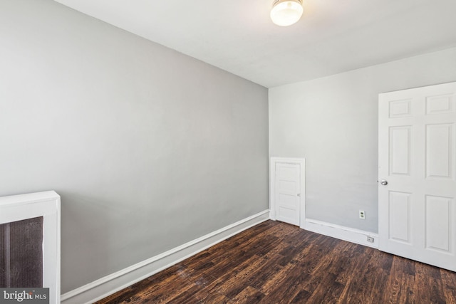 spare room featuring dark hardwood / wood-style flooring