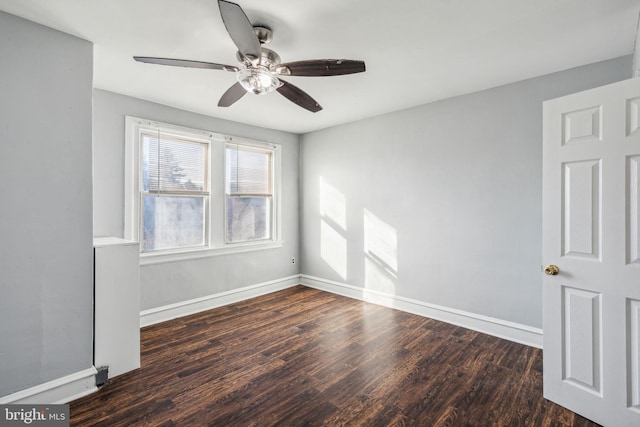 empty room featuring dark hardwood / wood-style floors and ceiling fan