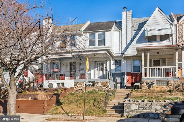 townhome / multi-family property with a porch