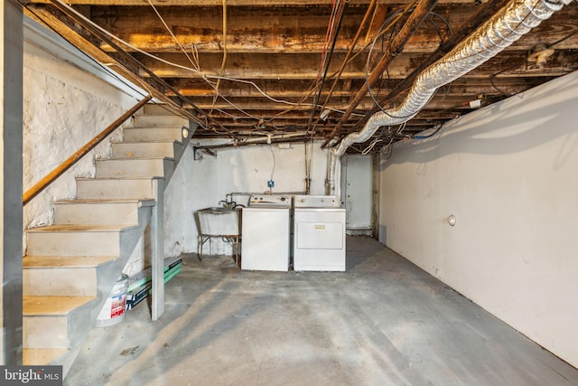 basement with washer and clothes dryer and sink