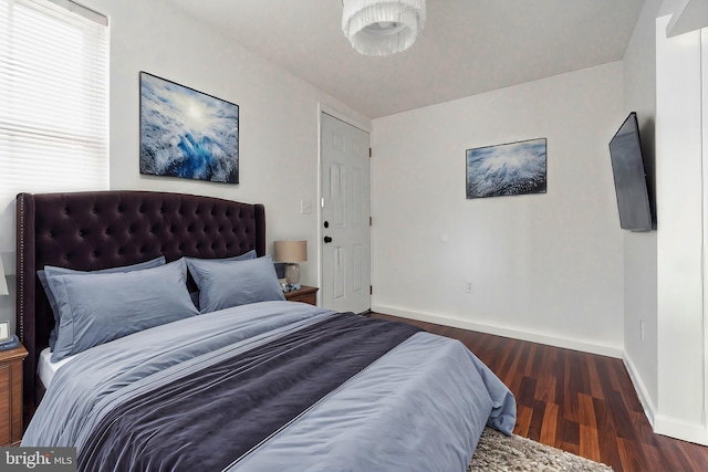 bedroom with dark hardwood / wood-style flooring