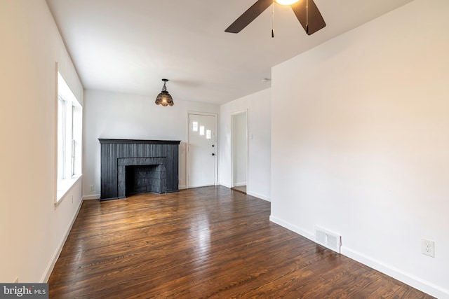 unfurnished living room featuring ceiling fan and dark hardwood / wood-style floors