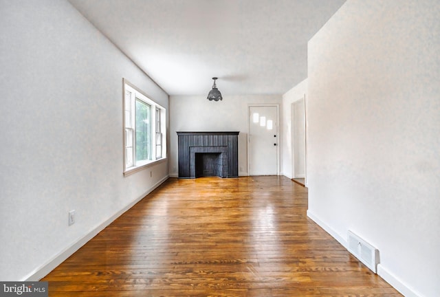 unfurnished living room featuring hardwood / wood-style flooring