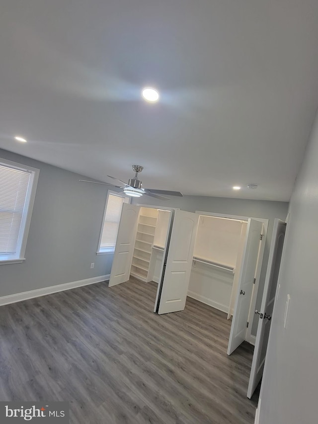 unfurnished bedroom with ceiling fan, dark hardwood / wood-style floors, a walk in closet, and a closet