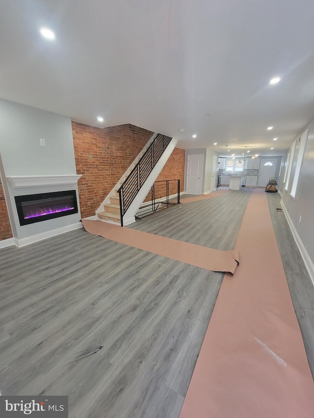 living room featuring a large fireplace and hardwood / wood-style flooring