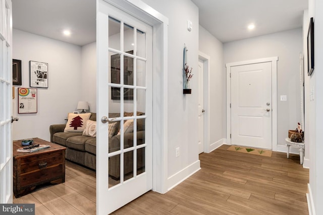 doorway with french doors and light hardwood / wood-style flooring